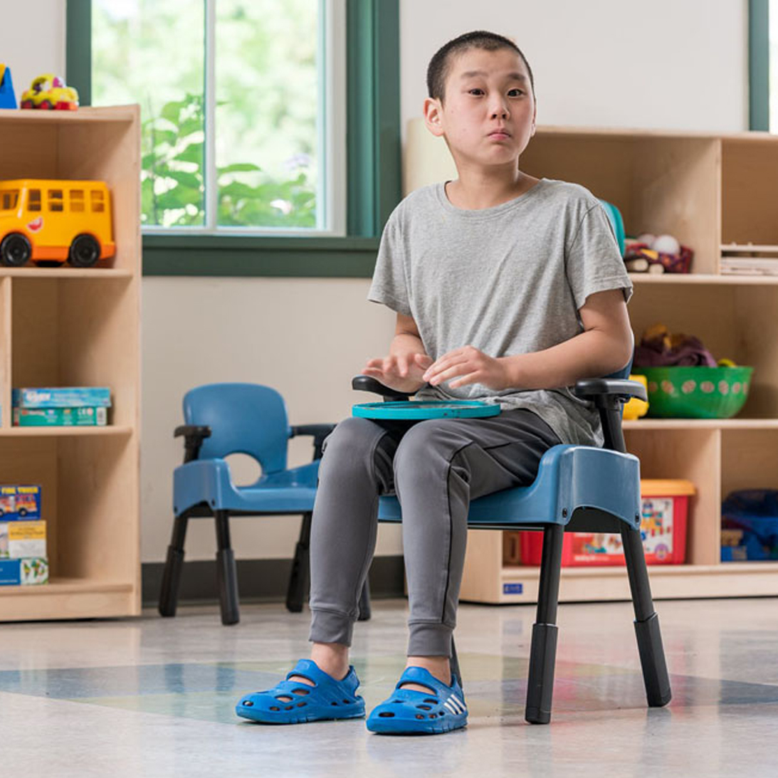 Young boy sit in his alternate seating in a classroom.