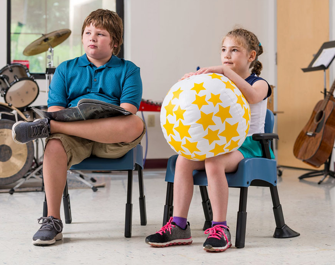 Students participating in music class whilst sitting on alternative seating.