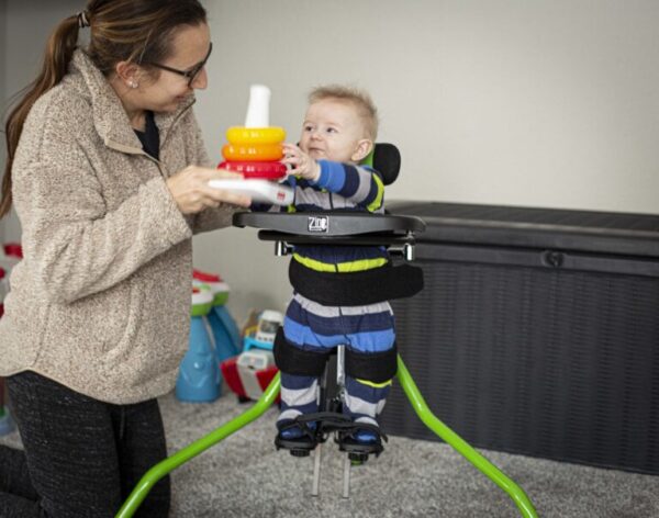 Zing Portable Stander with a toddler playing