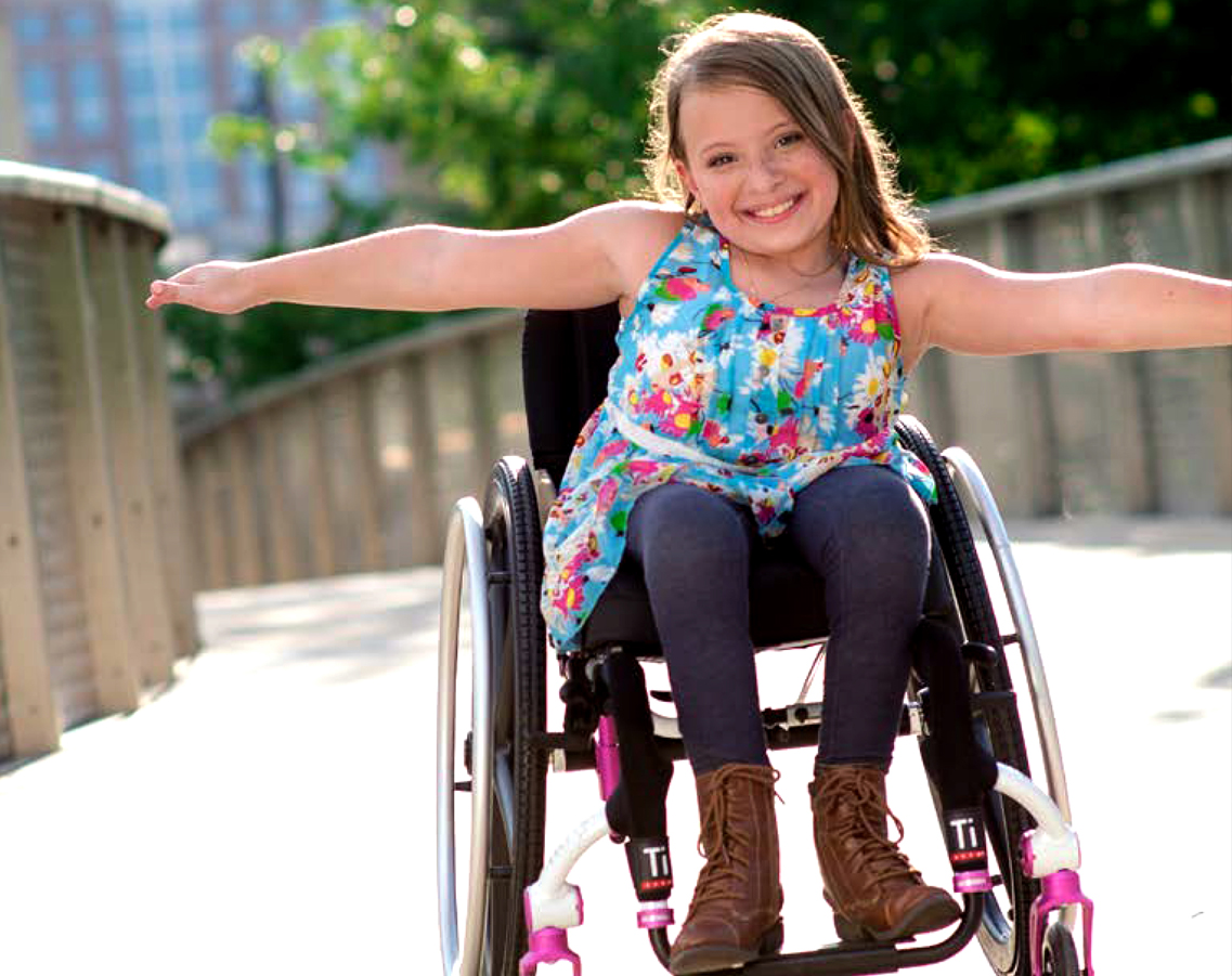 Kids Wheelchair image for blog post with a young girl on a Tilite manual wheelchair made for kids.