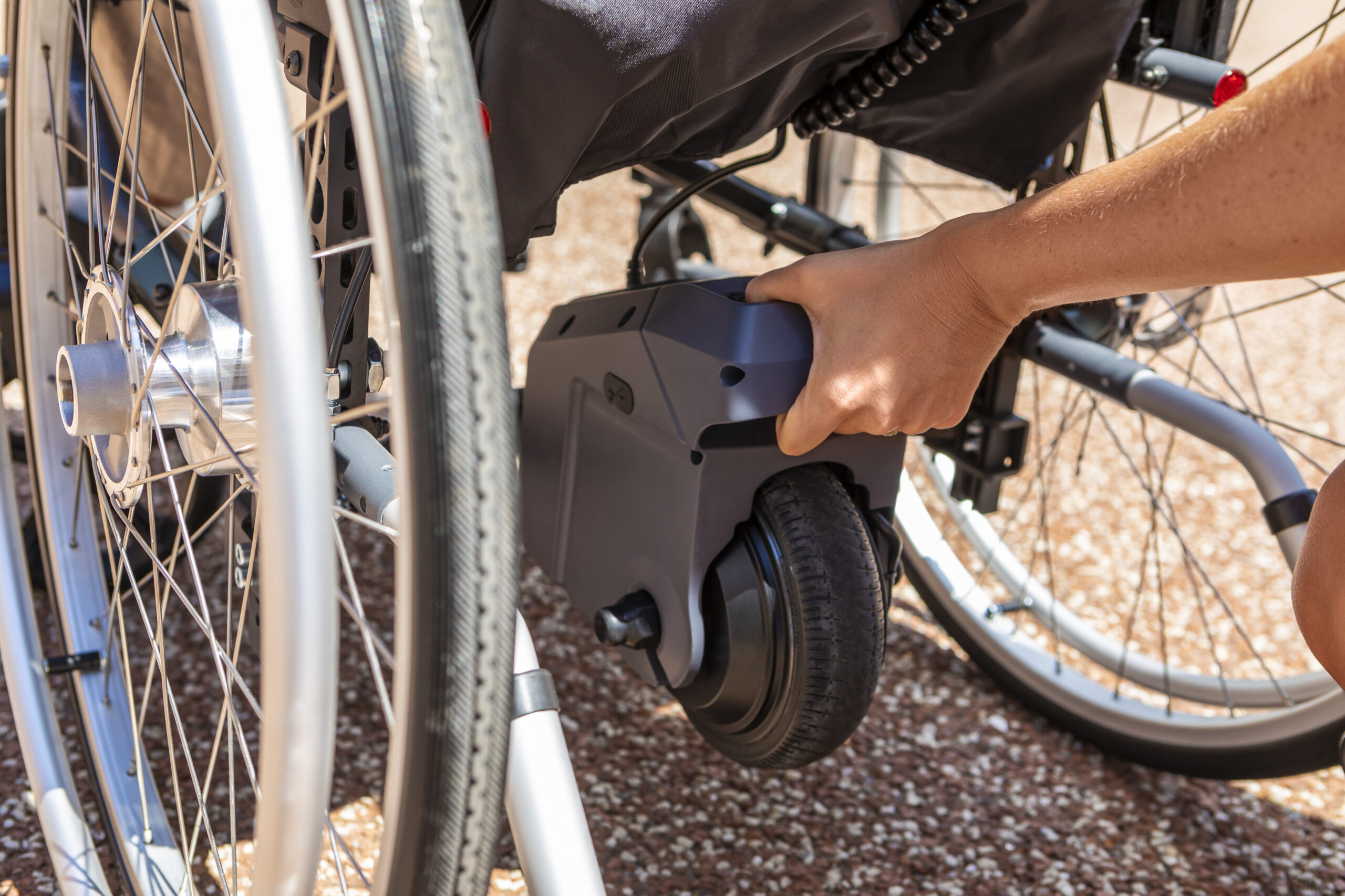 Alber Via Go wheelchair power assist being attached to a wheelchair